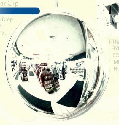 DomeVex wide-angle mirror hung from a convenience store drop ceiling reflecting shelving and the checkout area
