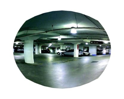Convex mirror view of a parking garage level showing columns, parked cars, and the drive aisle